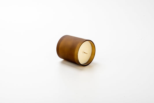 Candle in a wooden holder on a white background
