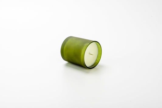 Green candle on a white background