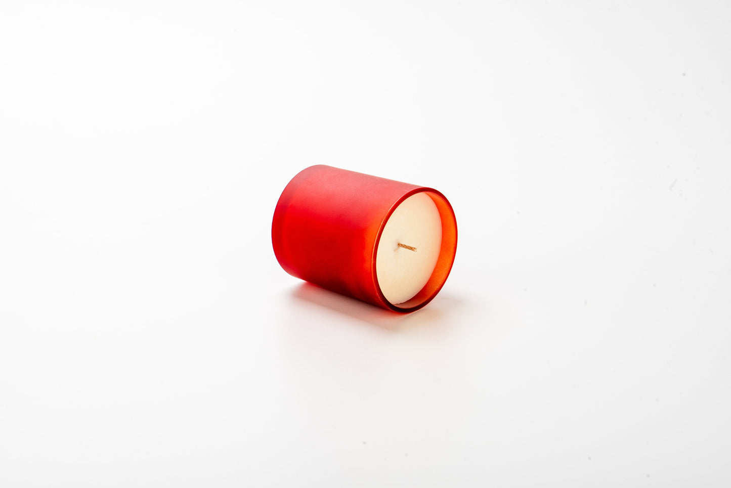 Red candle on a white background