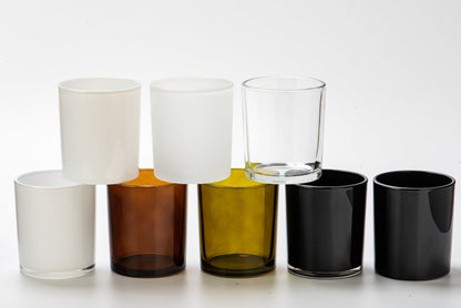 Set of glass candle holders in various colors on a white background