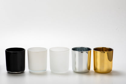 Five metallic cups in black, white, silver, and gold on a white background