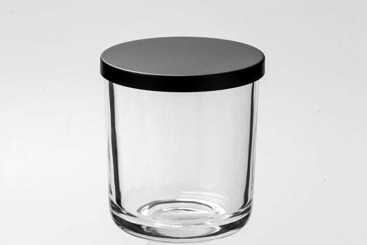 Clear glass jar with a black lid on a white background