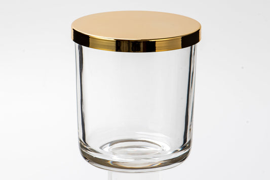 Clear glass jar with a gold lid on a white background