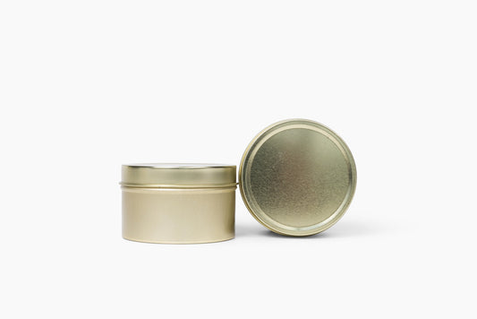 Aroma Crafters 4oz gold tin custom candle shown with the lid off, white background